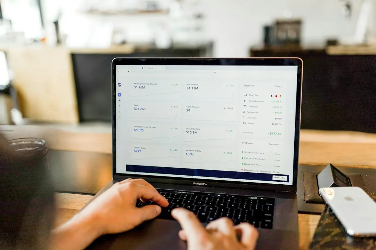 Hands typing on a laptop with an email inbox open